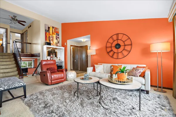 a living room with furniture and a dining table