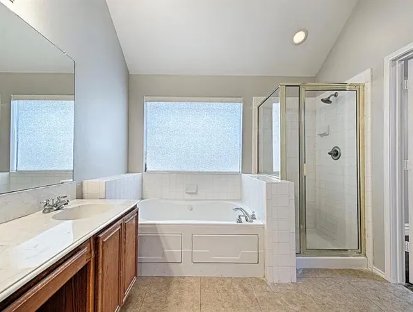 a bathroom with a sink toilet tub and shower
