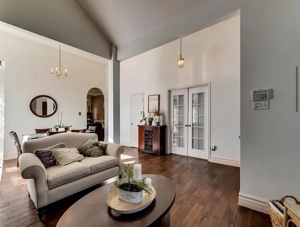 a living room with furniture and a wooden floor