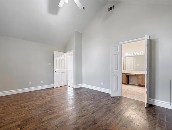 a view of a kitchen with a sink cabinets and wooden floor