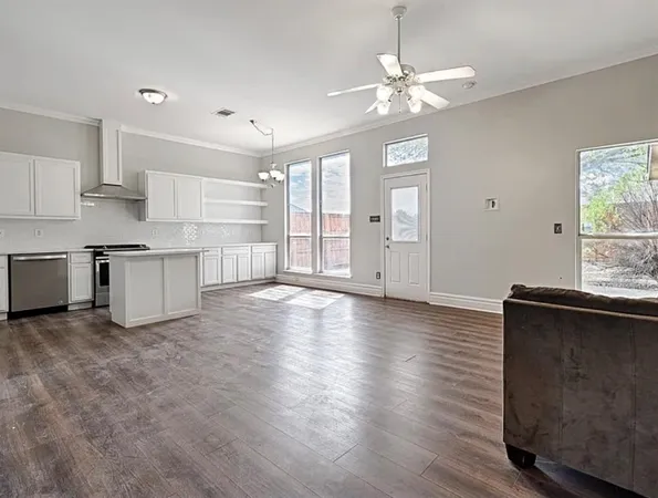 a kitchen with white cabinets and a stove
