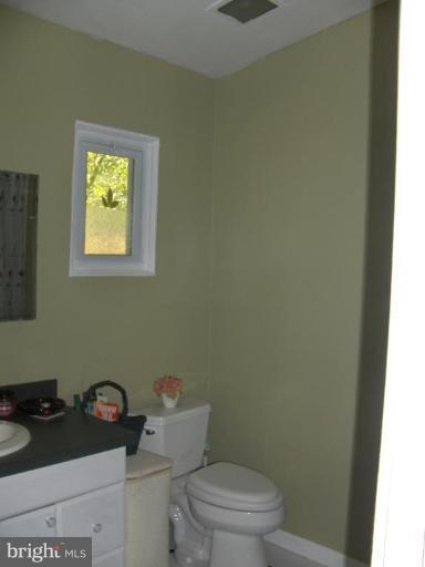 601 Kerwin Road Silver Spring, MD 20901 - Photo 7 of 13 a bathroom with a toilet a sink and a window