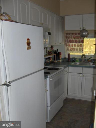 601 Kerwin Road Silver Spring, MD 20901 - Photo 10 of 13 a kitchen with a sink and white cabinets