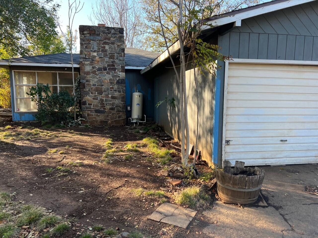 6764 Airport Road Redding, CA 96002 - Photo 1 of 22 a view of a house with a yard