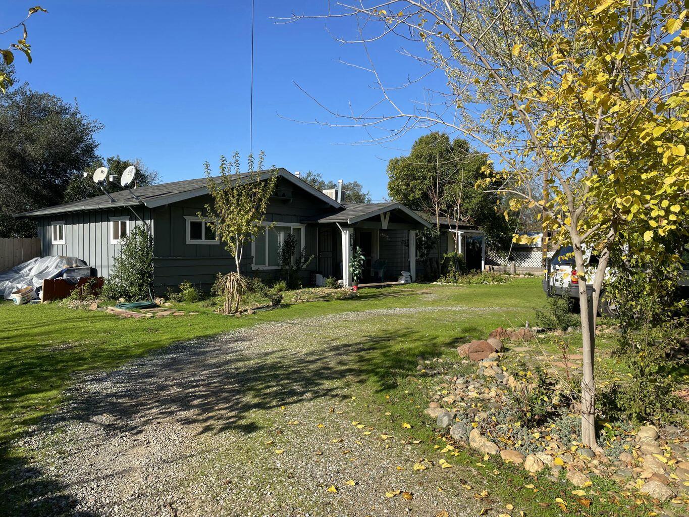 6764 Airport Road Redding, CA 96002 - Photo 11 of 22 a front view of a house with garden