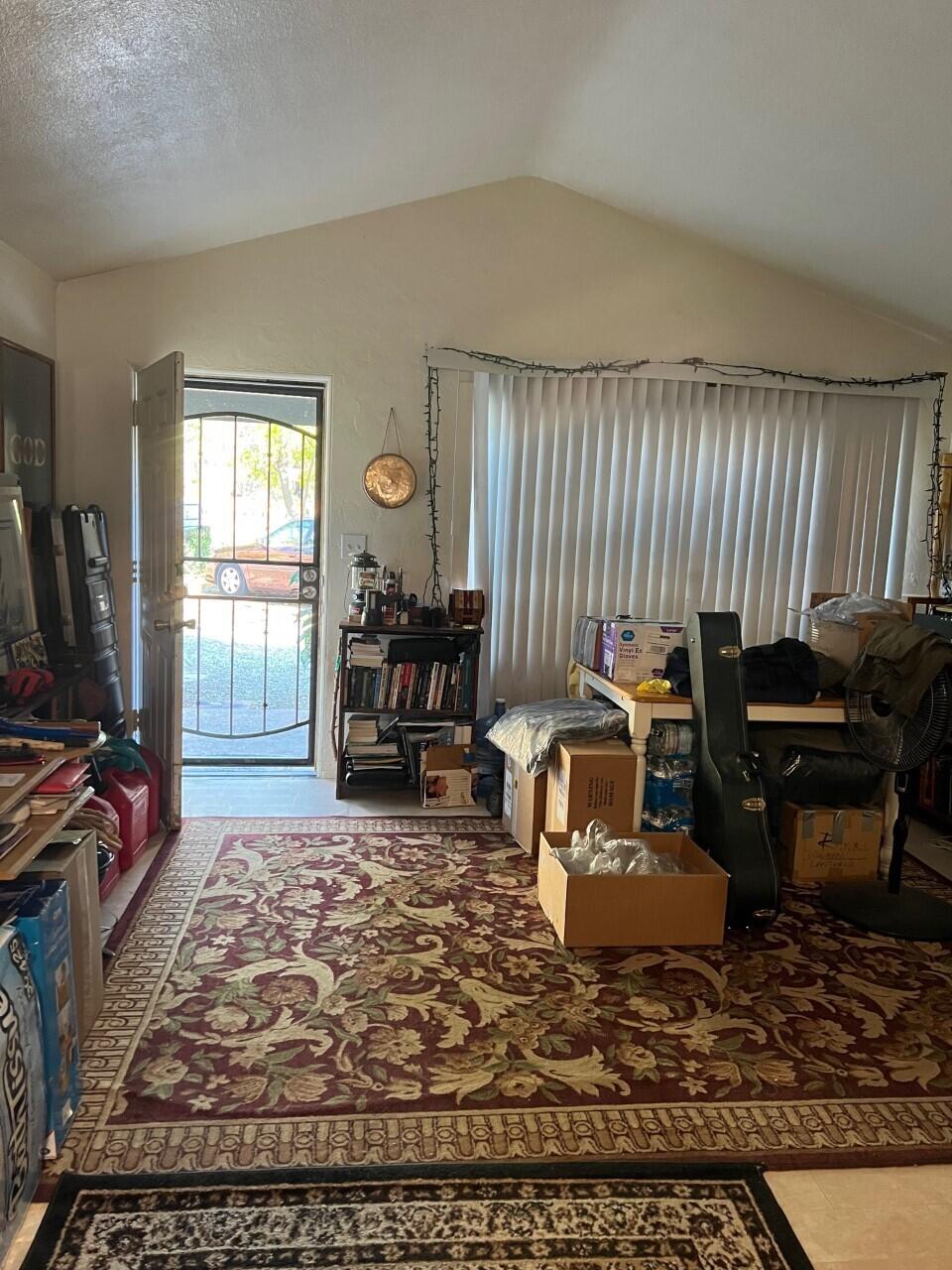 6764 Airport Road Redding, CA 96002 - Photo 20 of 22 a living room with furniture rug and a window
