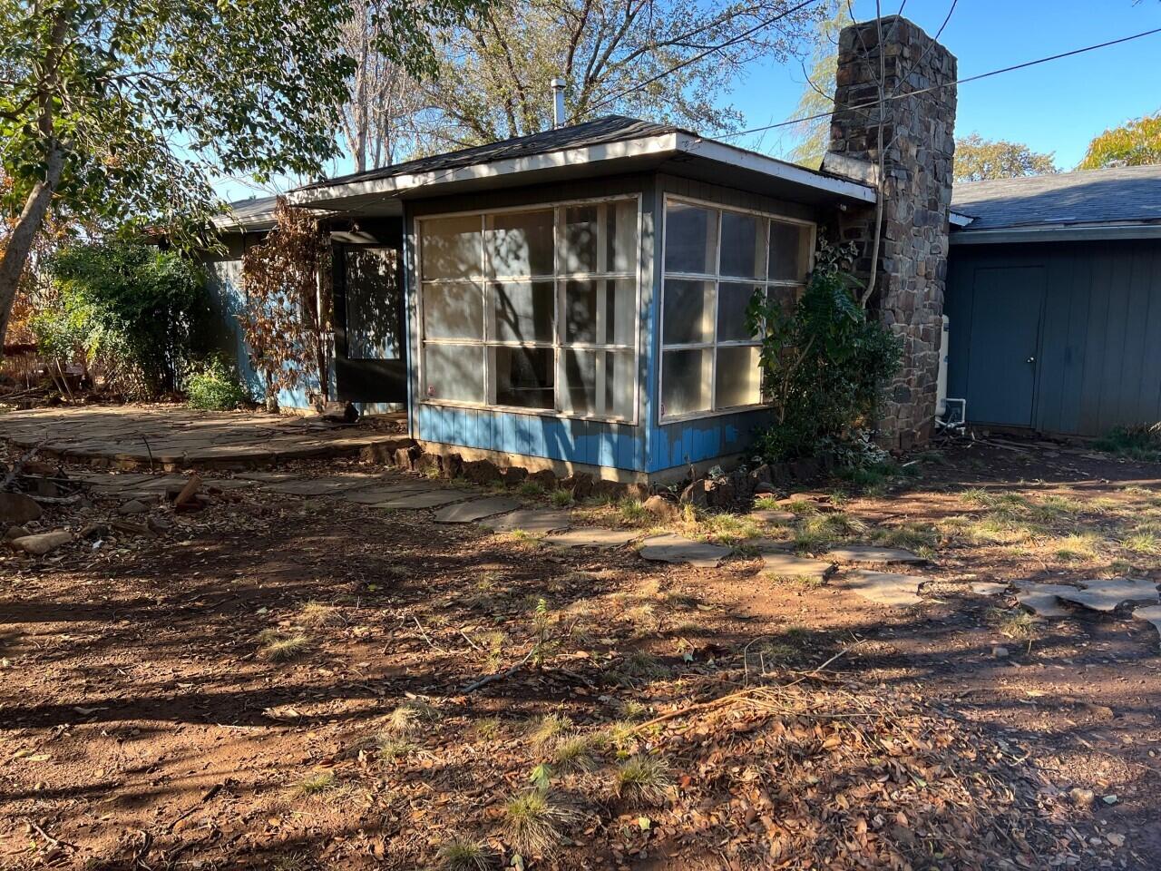 6764 Airport Road Redding, CA 96002 - Photo 2 of 22 a front view of a house with garden