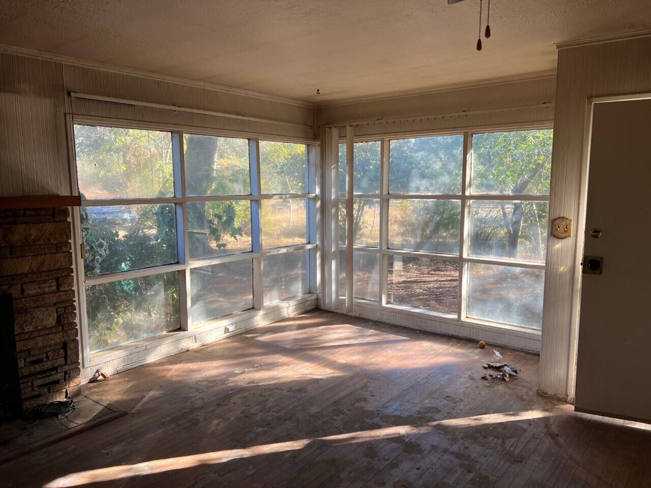 6764 Airport Road Redding, CA 96002 - Photo 4 of 22 a view of empty room with wooden floor and fan