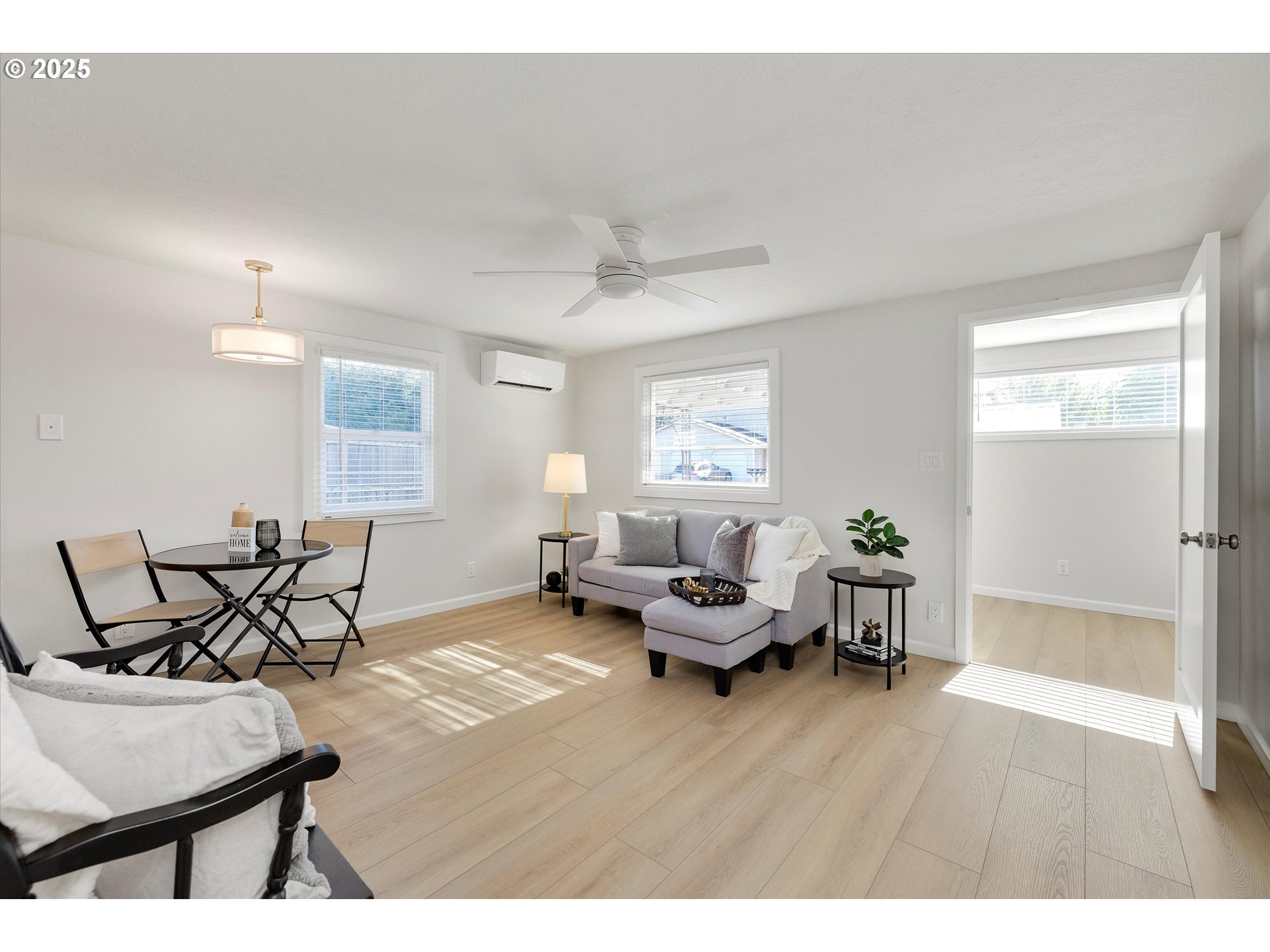18149 Southeast Pine Street Portland, OR 97233 - Photo 11 of 36 a living room with furniture and a wooden floor