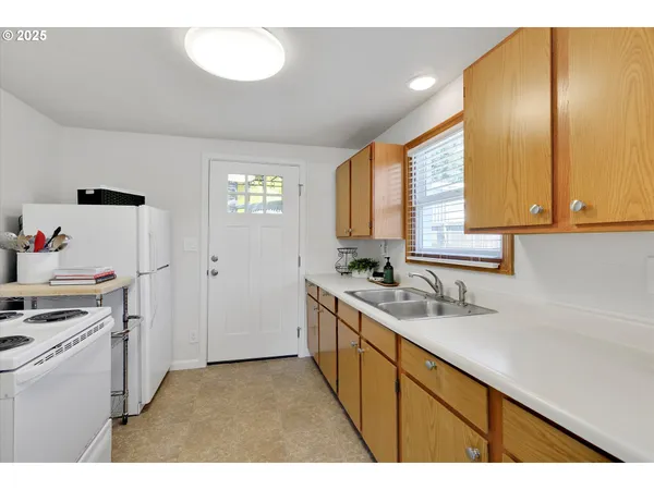 a kitchen with a sink cabinets and appliances