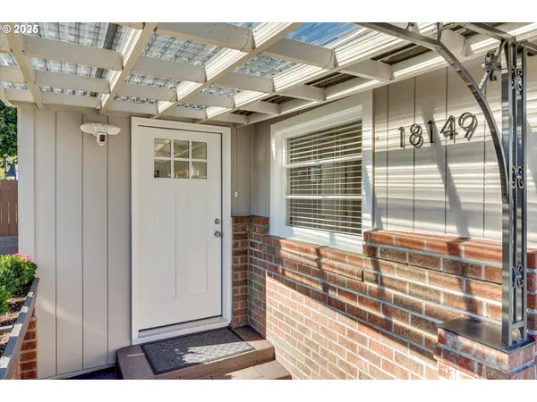 a couple of people sitting in front of a house