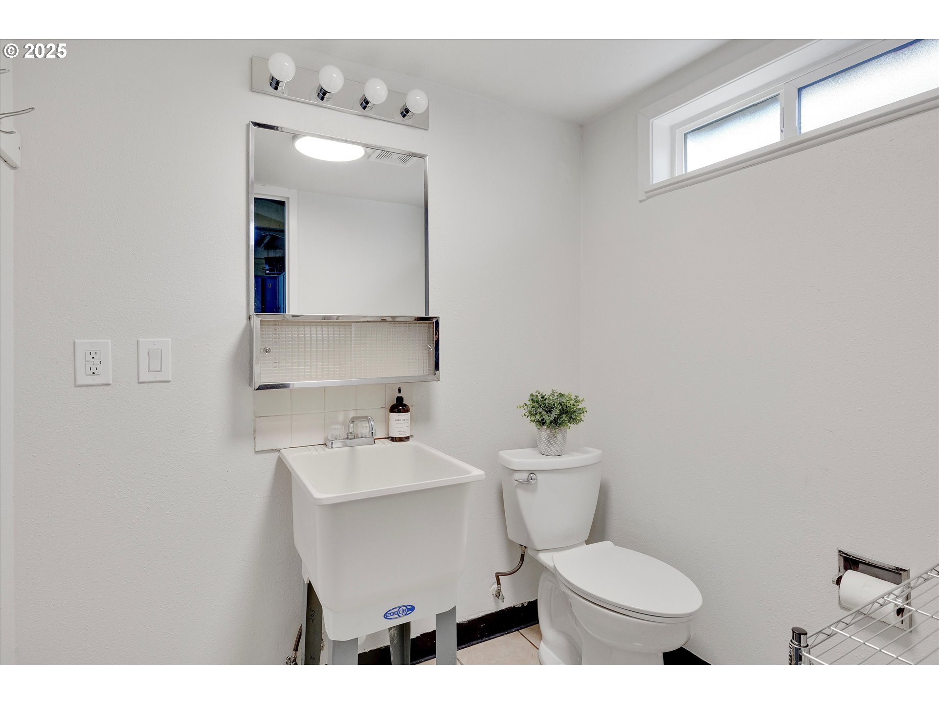18149 Southeast Pine Street Portland, OR 97233 - Photo 34 of 36 a bathroom with a sink mirror and toilet