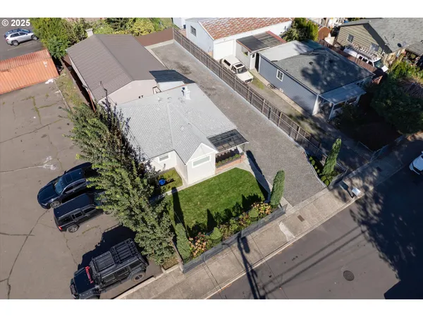 an aerial view of a house with a yard