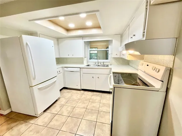 a white refrigerator freezer sitting inside of a kitchen