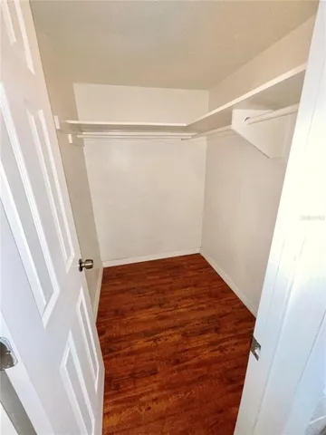 a view of a room with wooden floor and white walls
