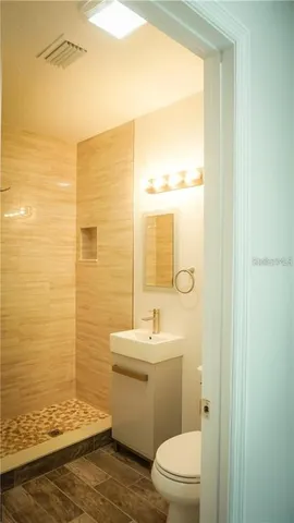 a bathroom with a toilet a sink and a window