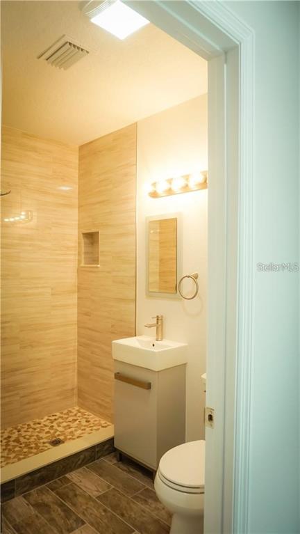 3409 Vidal Street New Port Richey, FL 34655 - Photo 6 of 8 a bathroom with a toilet a sink and a window