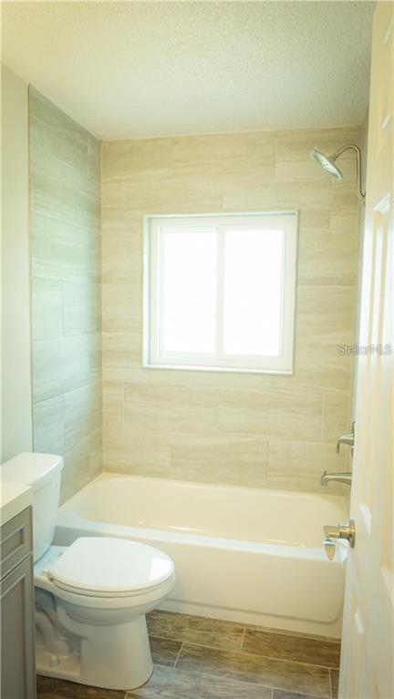 3409 Vidal Street New Port Richey, FL 34655 - Photo 8 of 8 a bathroom with a toilet and a bathtub