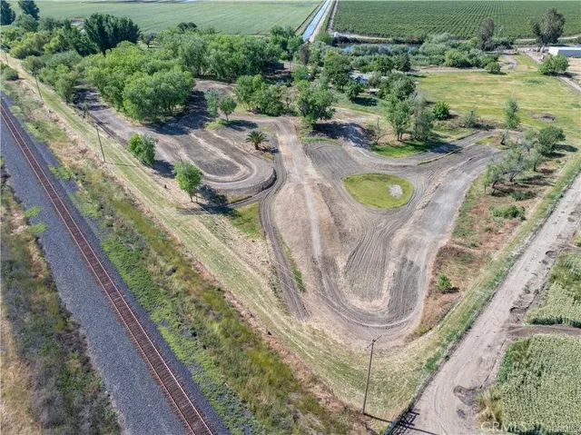 an aerial view of a house a yard and outdoor seating