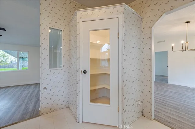 a view of an empty room and wooden floor