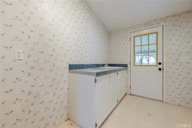 a view of dirt field with trees in the background