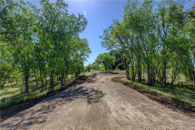 a view of a chair and table on the side of the road