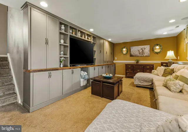 a bedroom with furniture and a flat screen tv