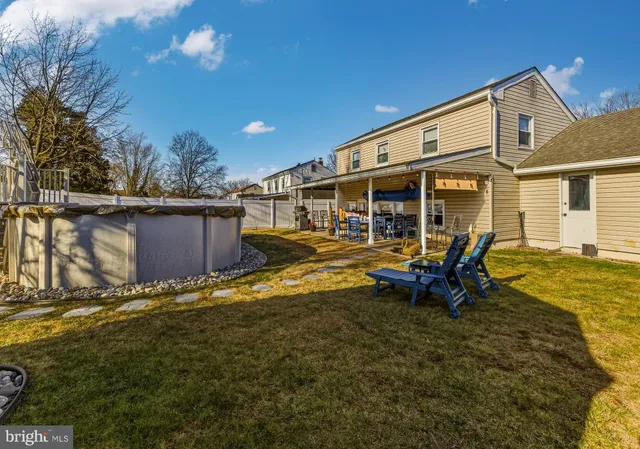a view of a house with backyard porch and sitting area