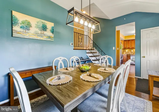a dining room with furniture and wooden floor