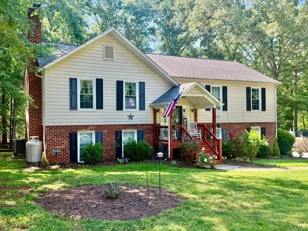 a view of a house with a yard and plants