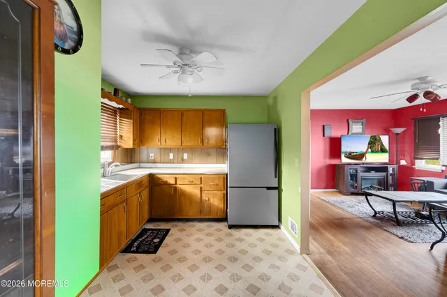 a kitchen with a refrigerator sink and cabinets