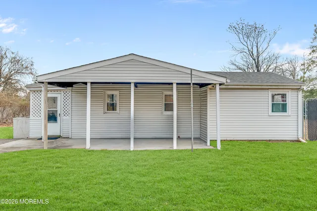 a big house with a big yard and large trees