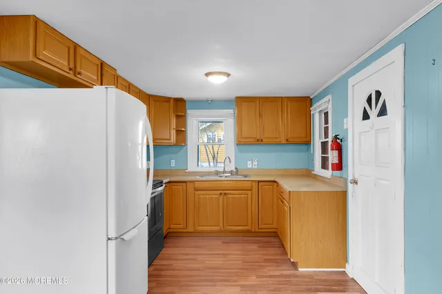 a kitchen with stainless steel appliances a refrigerator and a stove top oven