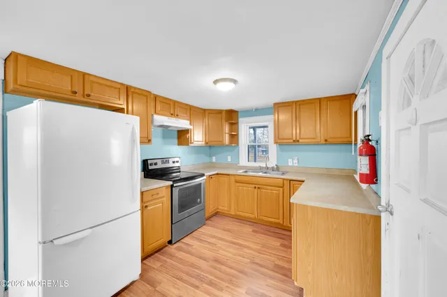 a kitchen with a refrigerator and a sink