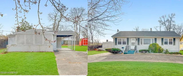 a view of an house with backyard space and a tree