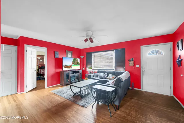 a living room with furniture a rug and a large window