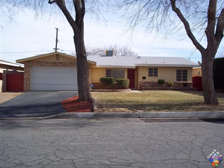 43940 3rd Street East Lancaster, CA 93535 - Photo 1 of 18 a front view of house with yard and trees