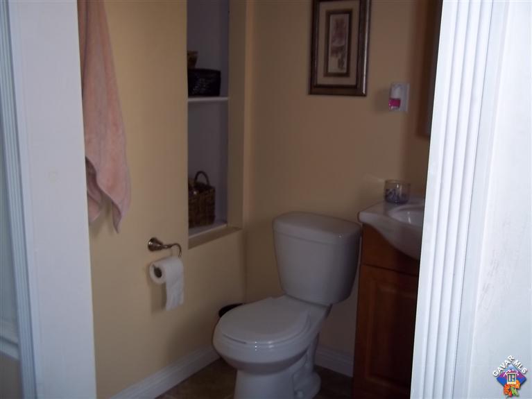 43940 3rd Street East Lancaster, CA 93535 - Photo 14 of 18 a white toilet sitting next to a bathroom sink