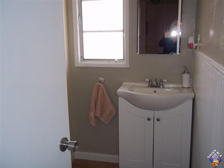 43940 3rd Street East Lancaster, CA 93535 - Photo 15 of 18 a bathroom with a sink and a mirror
