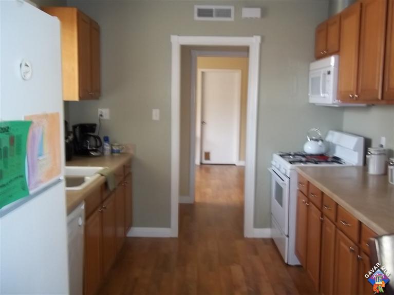 43940 3rd Street East Lancaster, CA 93535 - Photo 5 of 18 a kitchen with a sink a stove and cabinets