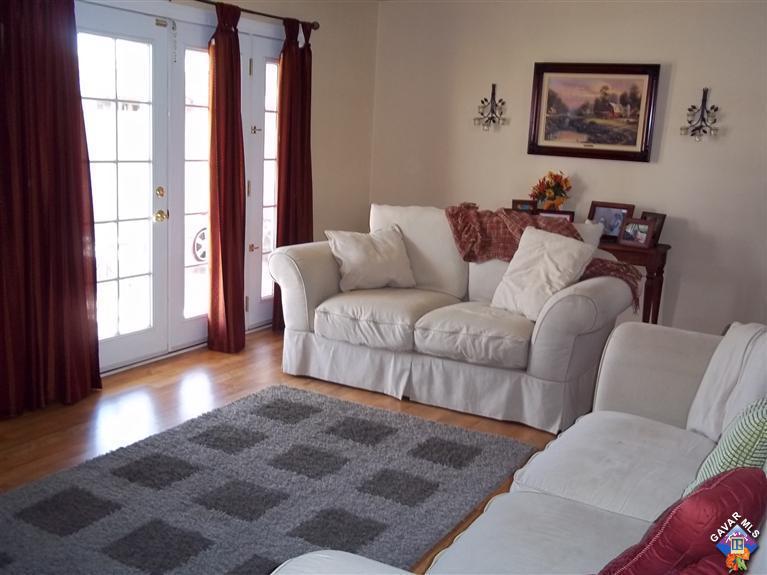 43940 3rd Street East Lancaster, CA 93535 - Photo 9 of 18 a living room with furniture and large window with wooden floor