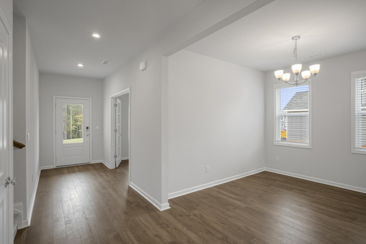 195 Madden Rose Loop Garner, NC 27529 - Photo 11 of 37 a view of livingroom with hardwood floor and window