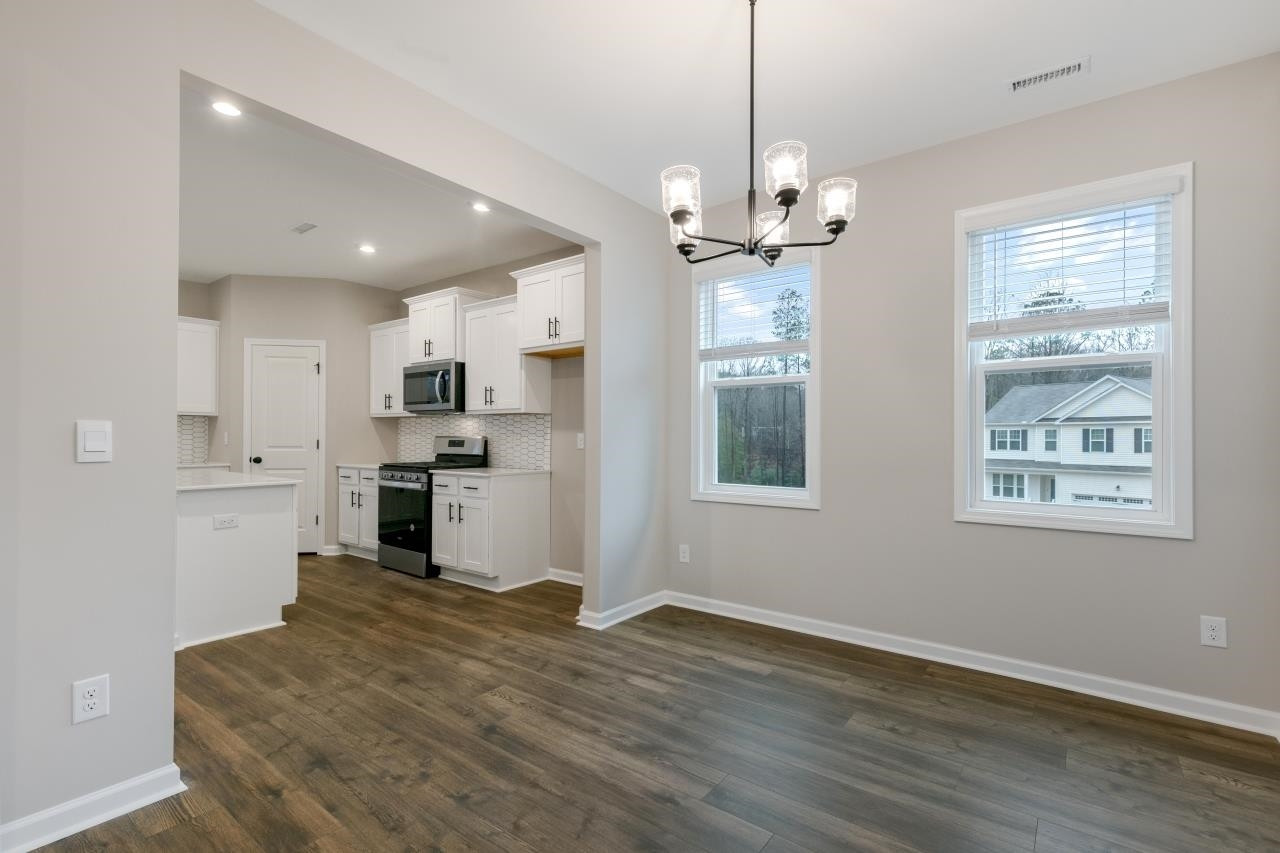 195 Madden Rose Loop Garner, NC 27529 - Photo 13 of 37 a open kitchen with window and stainless steel appliances