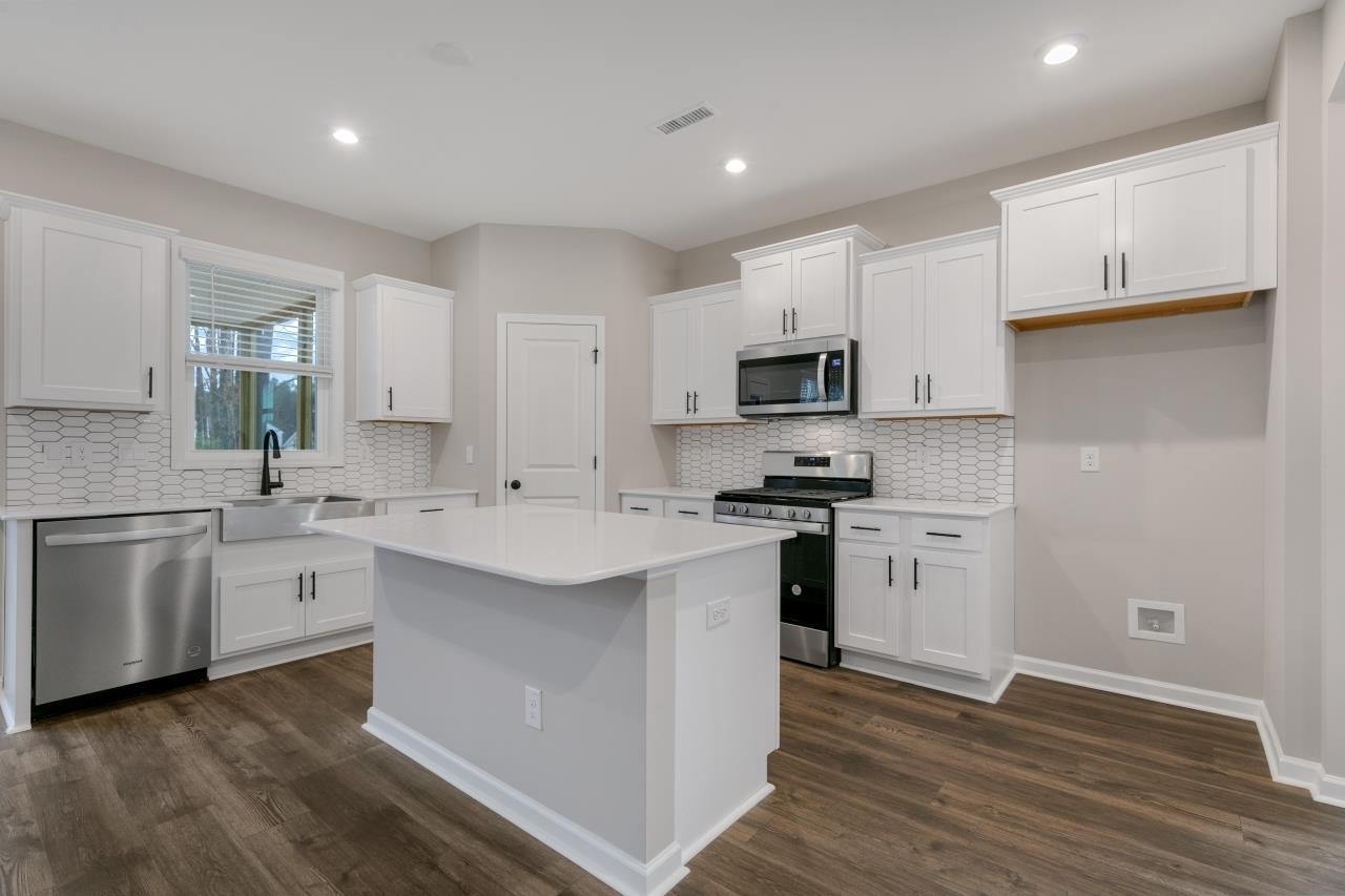 195 Madden Rose Loop Garner, NC 27529 - Photo 14 of 37 a kitchen with appliances cabinets and a sink
