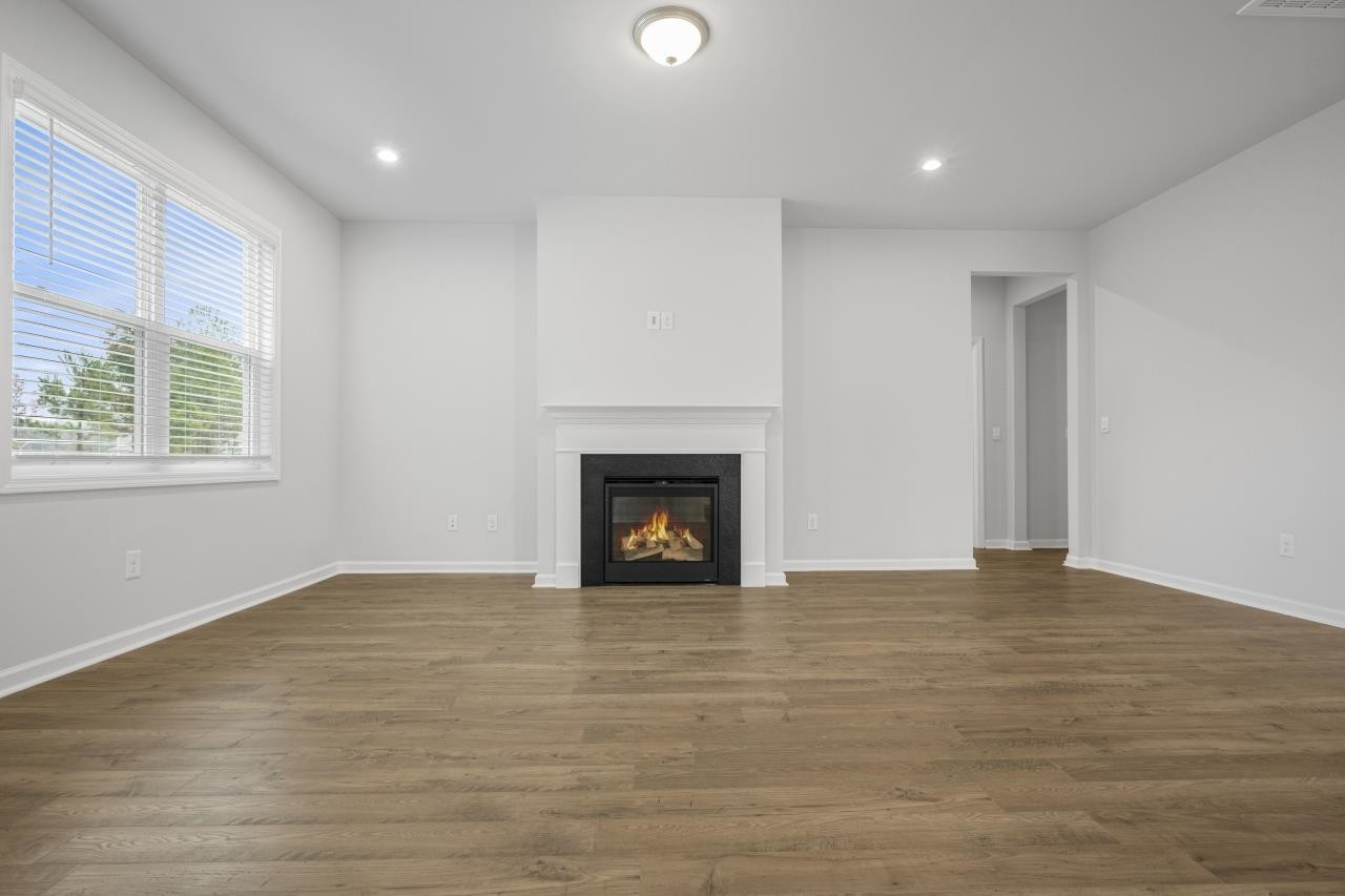 195 Madden Rose Loop Garner, NC 27529 - Photo 17 of 37 a view of an empty room with a window and fireplace