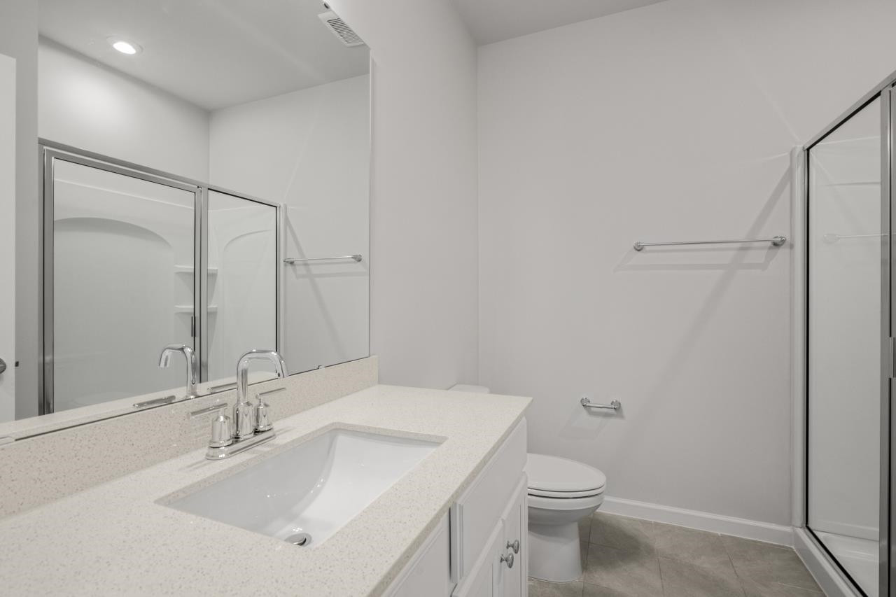 195 Madden Rose Loop Garner, NC 27529 - Photo 23 of 37 a bathroom with a sink a toilet and a mirror