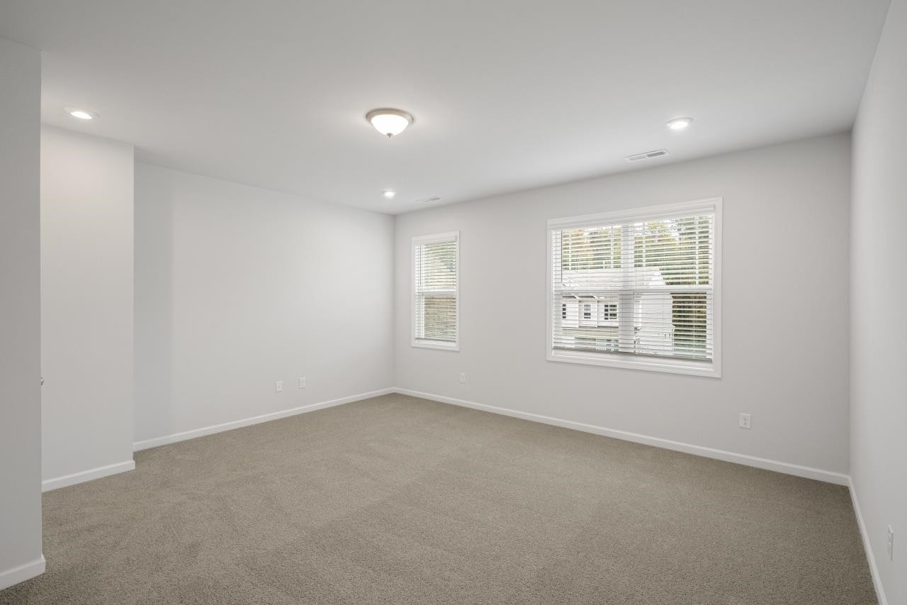 195 Madden Rose Loop Garner, NC 27529 - Photo 24 of 37 an empty room with windows