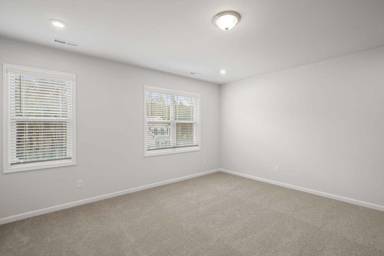 195 Madden Rose Loop Garner, NC 27529 - Photo 25 of 37 an empty room with windows
