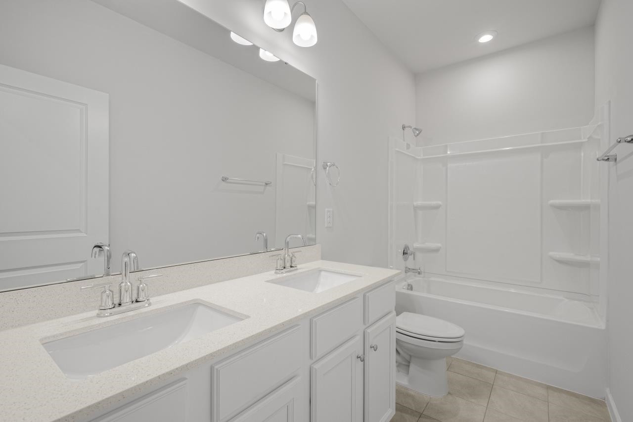 195 Madden Rose Loop Garner, NC 27529 - Photo 26 of 37 a bathroom with a sink a toilet and shower