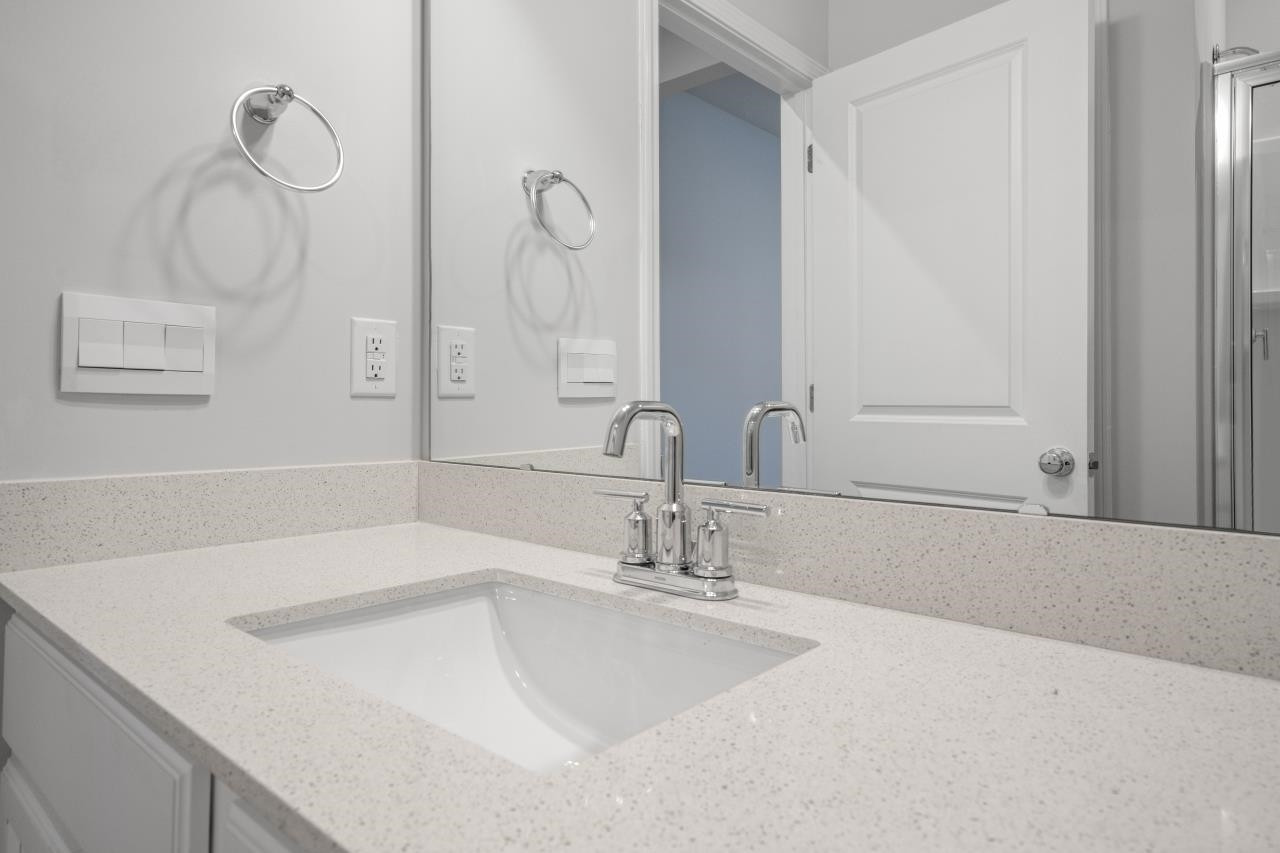 195 Madden Rose Loop Garner, NC 27529 - Photo 27 of 37 a bathroom with a sink and a mirror